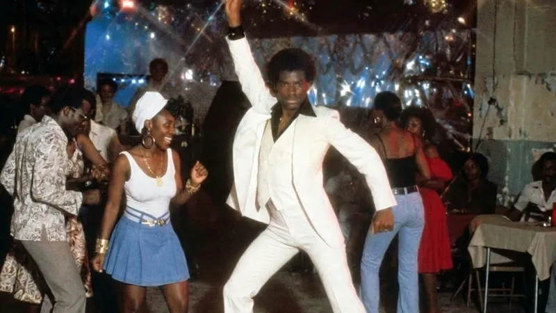 Vintage Disco - man in white suite striking a dance pose